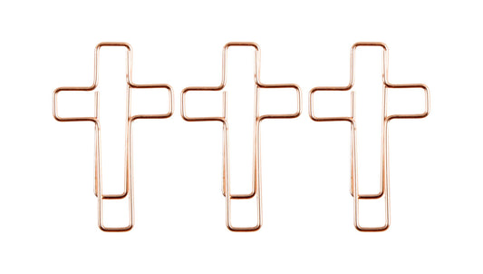 Three rose gold cross-shaped paper clips on a white background