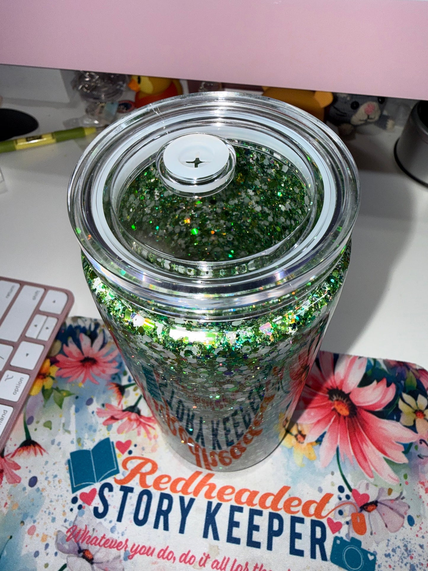 20 oz Eagles Glitter Tumbler - top-down view showing clear snap lid with straw hole and green holographic glitter visible through lid