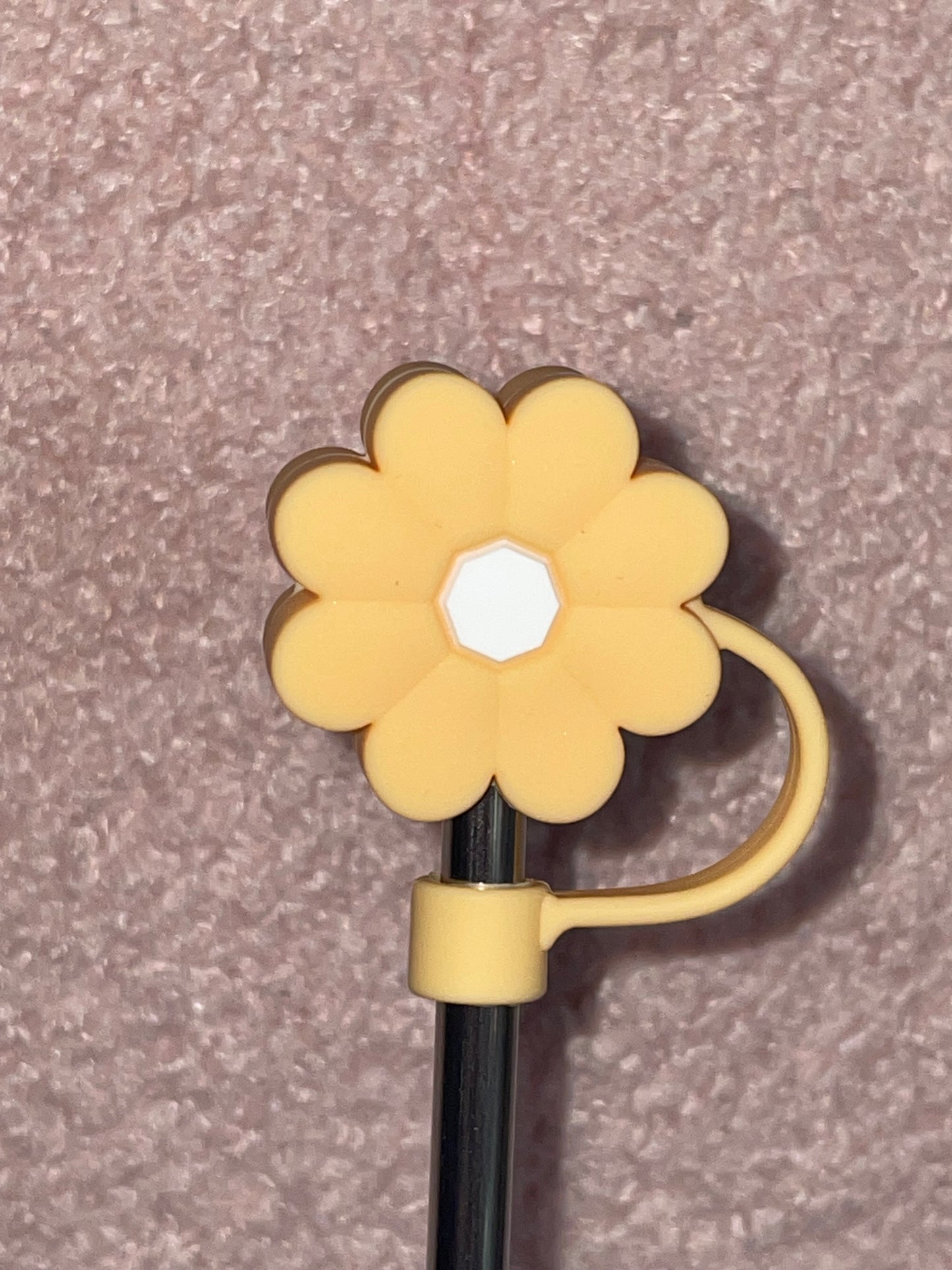 Yellow flower-shaped clip on a gray background