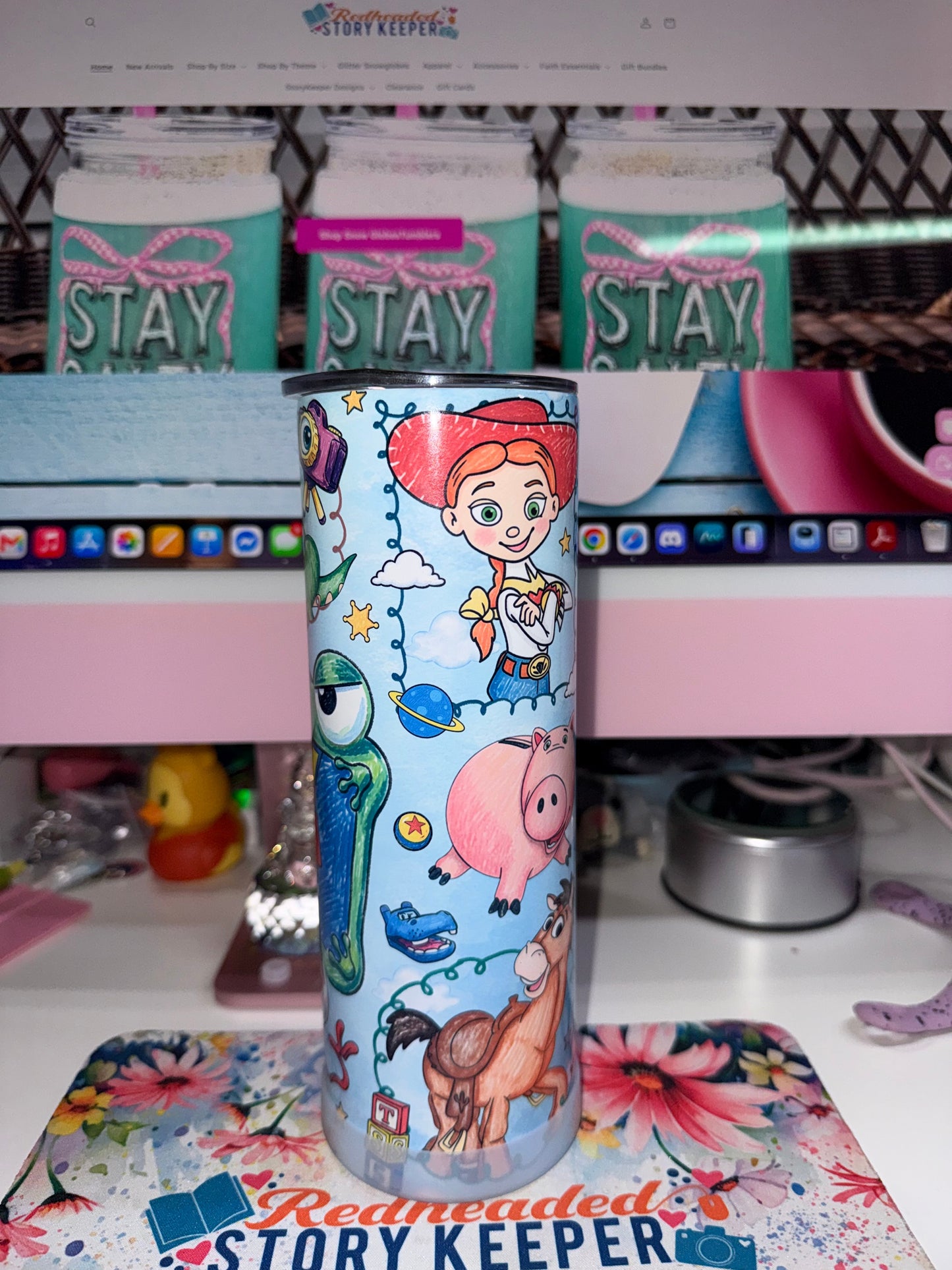 20 oz Toy Story 5 Tumbler - side 1 showing Jessie with Mike Wazowski, Hamm, Bullseye and Rex on sky blue background