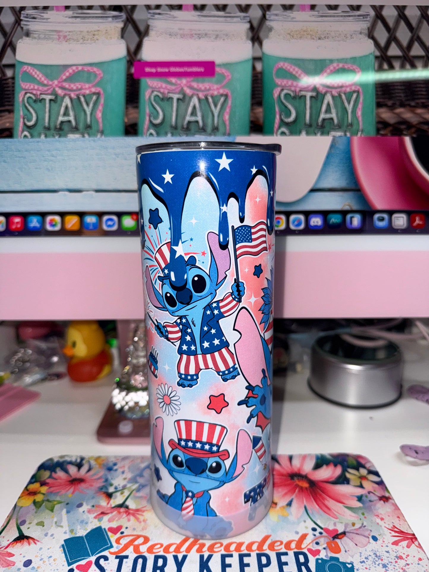 20 oz America Stitch Tumbler - side view showing Stitch in Uncle Sam hat waving flag with patriotic balloons and daisy accents