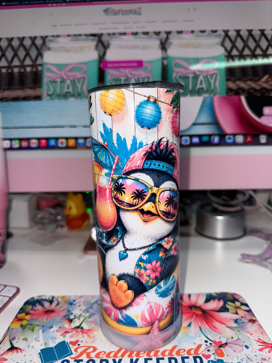 20 oz Too Cool To Care Tumbler - front view showing penguin in pink baseball cap and yellow sunglasses sipping tropical drink with lanterns and tropical leaves