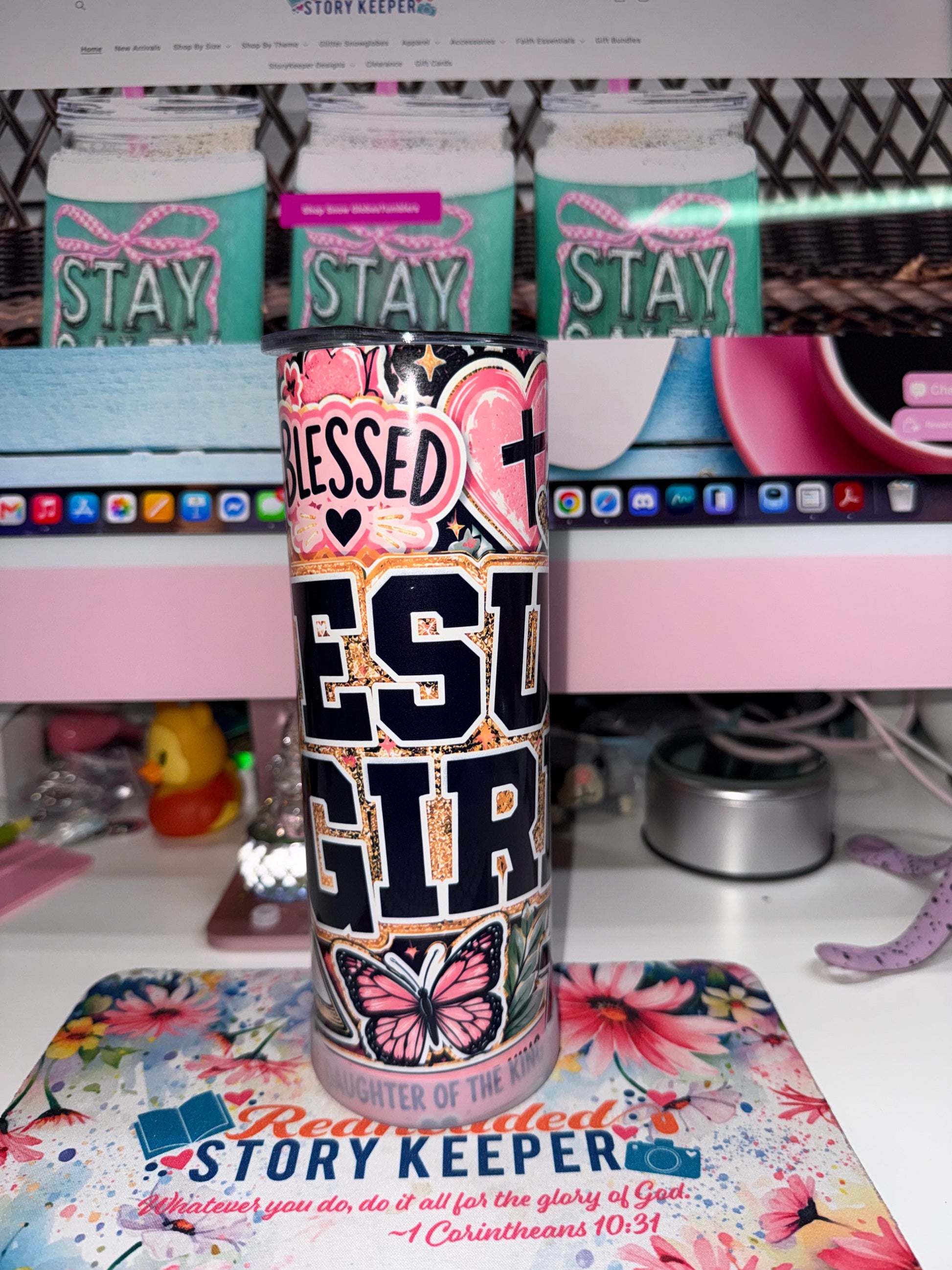 20 oz Blessed Jesus Girl Tumbler - front view showing Blessed Jesus Girl varsity lettering with pink heart, cross and butterfly on black background