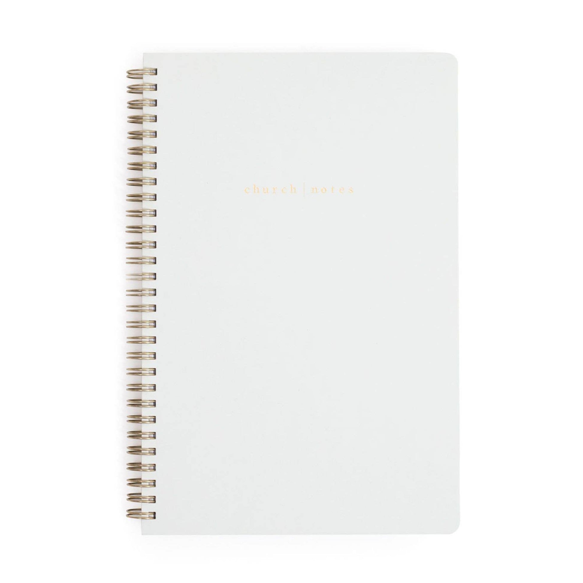 White notebook with spiral binding on a white background