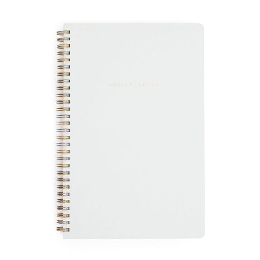 White notebook with spiral binding on a white background