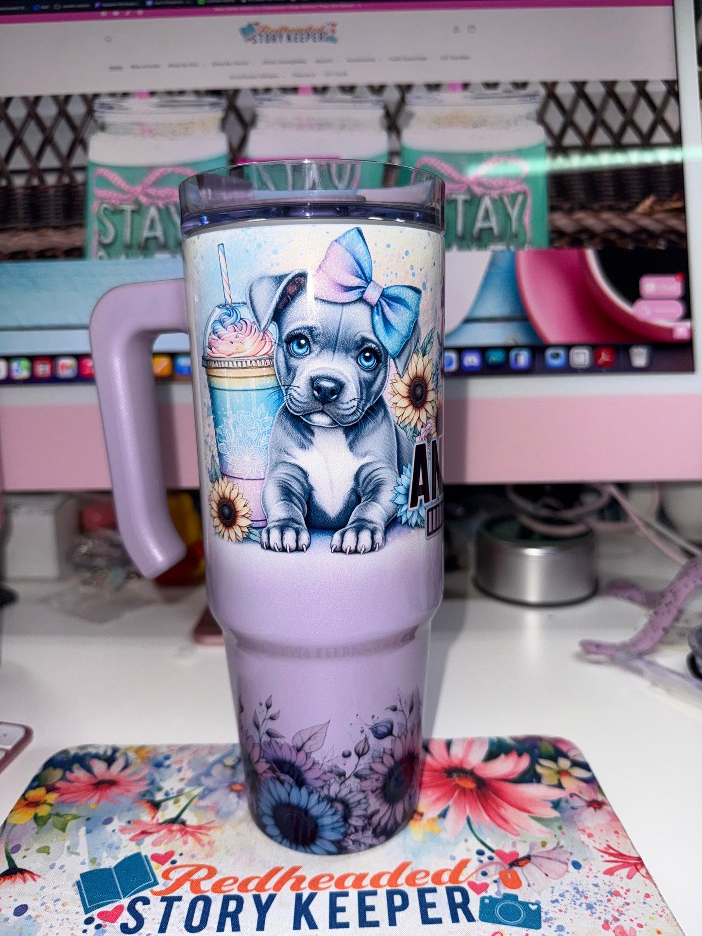 30 oz Anxiety Loading Grippy Tumbler Limited Edition - handle side view showing single pitbull puppy with blue bow holding a frappe cup surrounded by sunflowers