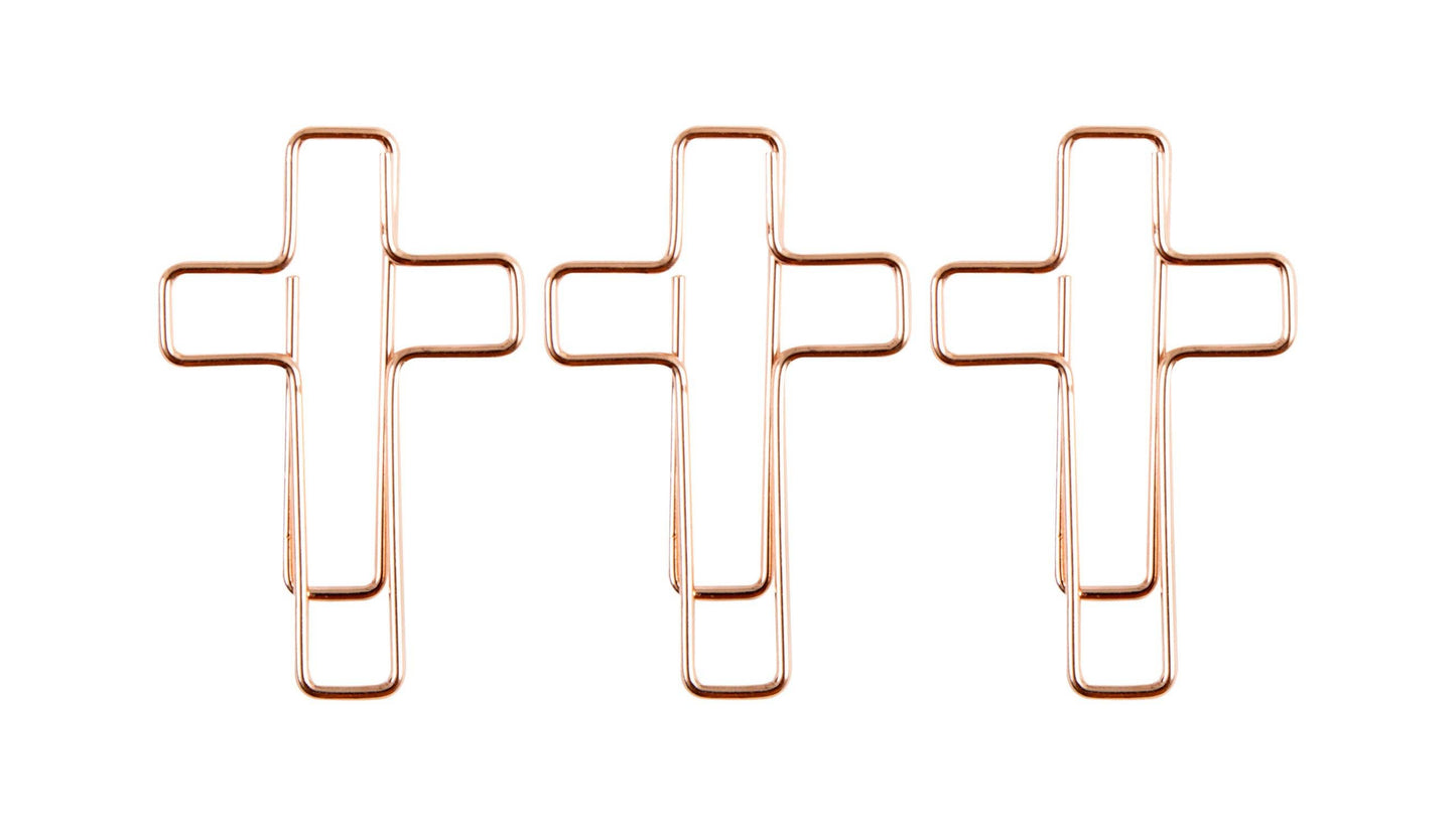 Three rose gold cross-shaped paper clips on a white background