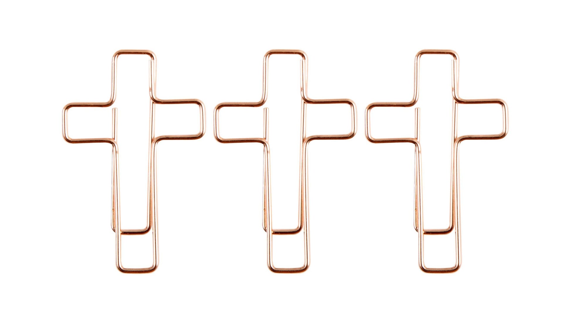 Three rose gold cross-shaped paper clips on a white background