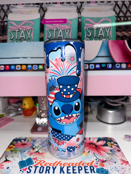 20 oz America Stitch Tumbler - front view showing Stitch in Uncle Sam hat with sunglasses, blue sunflower, fireworks and AMERICA text on blue drip background