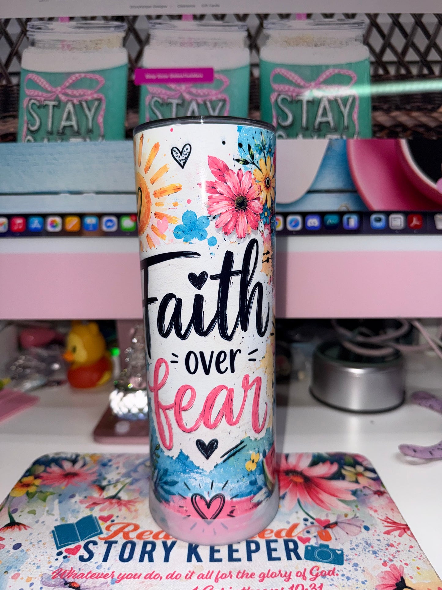 20 oz Faith Over Fear Tumbler - front view showing Faith over fear in bold brush lettering with colorful daisies sunflowers and pink florals