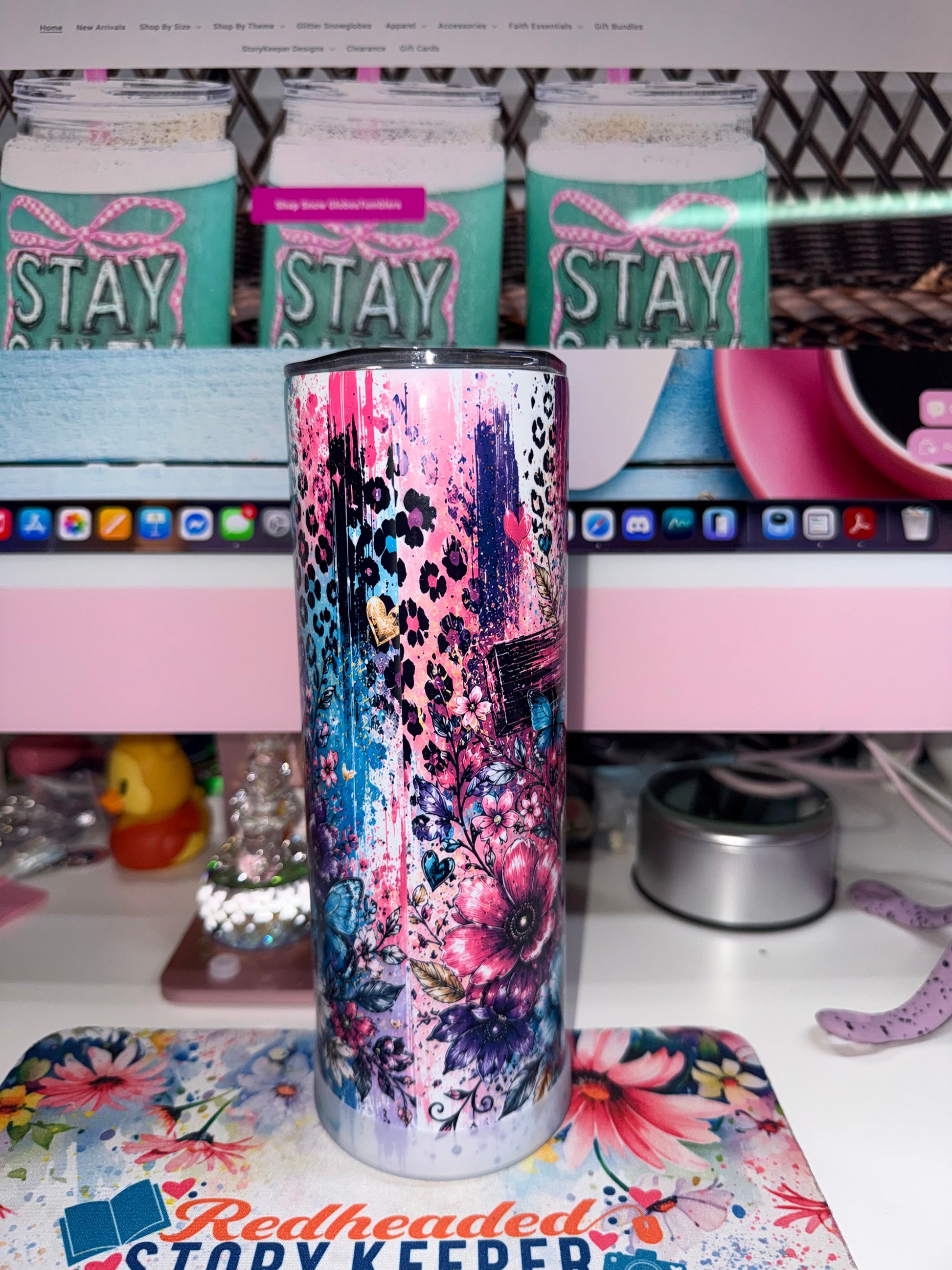 20 oz I Can Do All Things Through Christ Tumbler - back view showing lush pink and purple floral wrap with cross and blue butterfly details