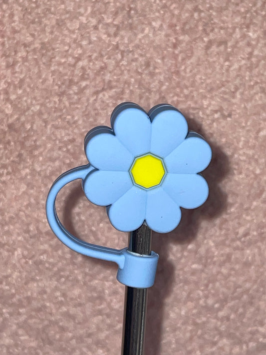 Blue flower-shaped clip on a brown background