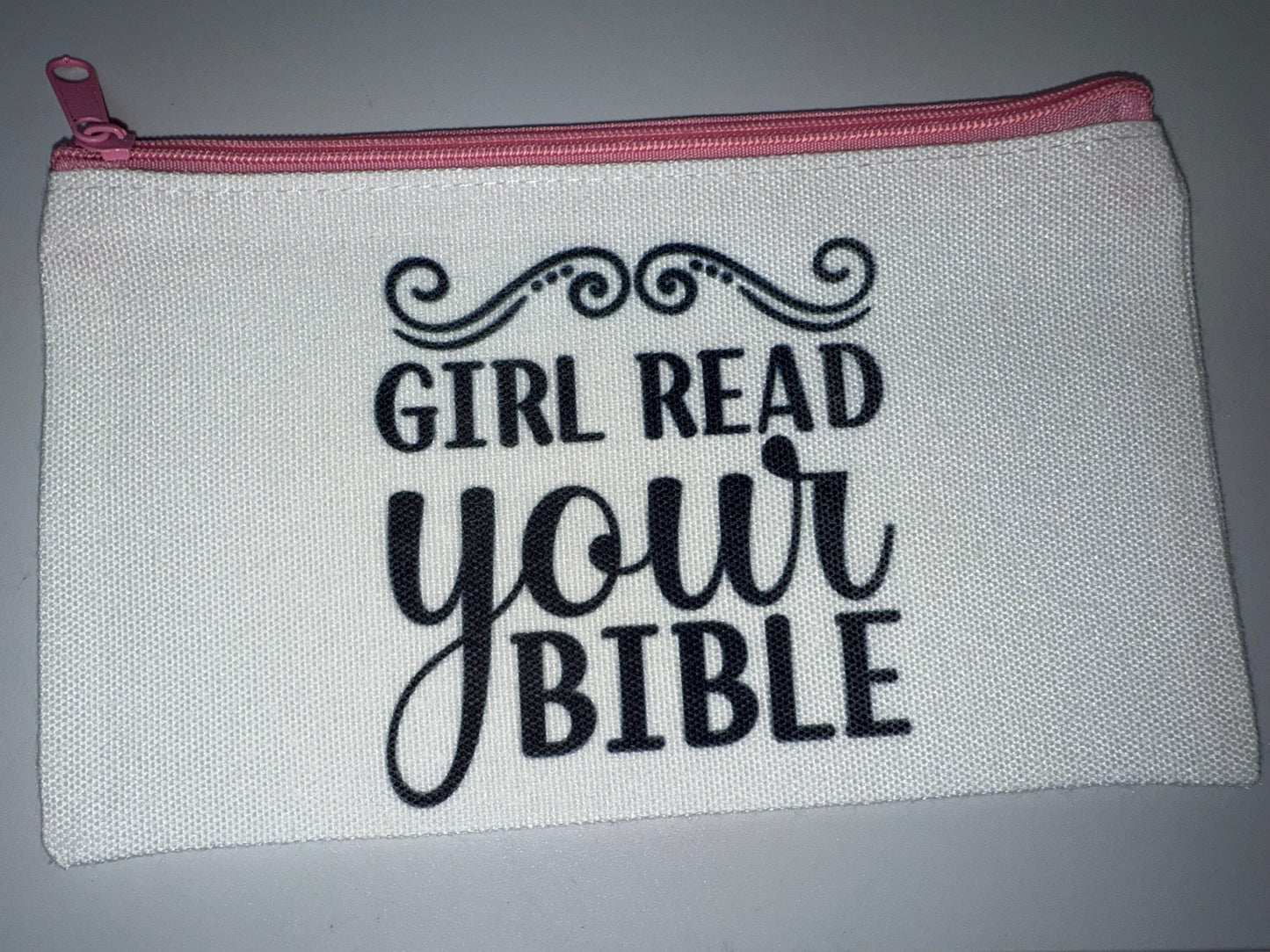 Pouch with 'Girl Read Your Bible' text on a gray background