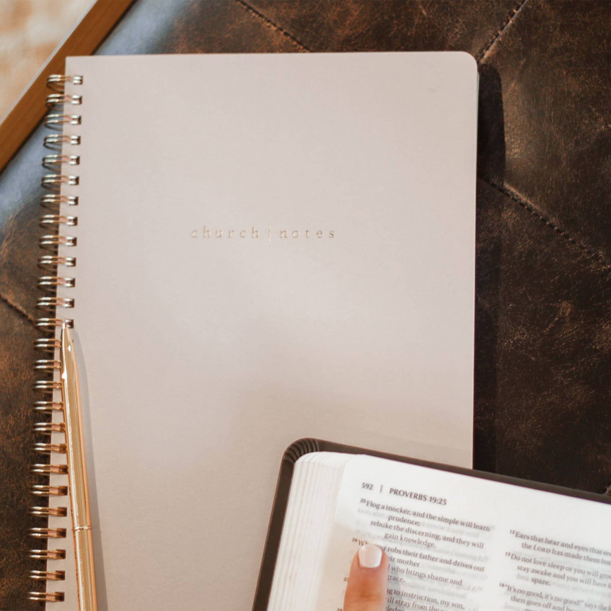 Notebook titled 'church notes' on a textured surface